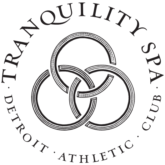 Tranquility Spa brandmark with a 3 interlocking rings elblem in the center with the wordmark around in a circle
