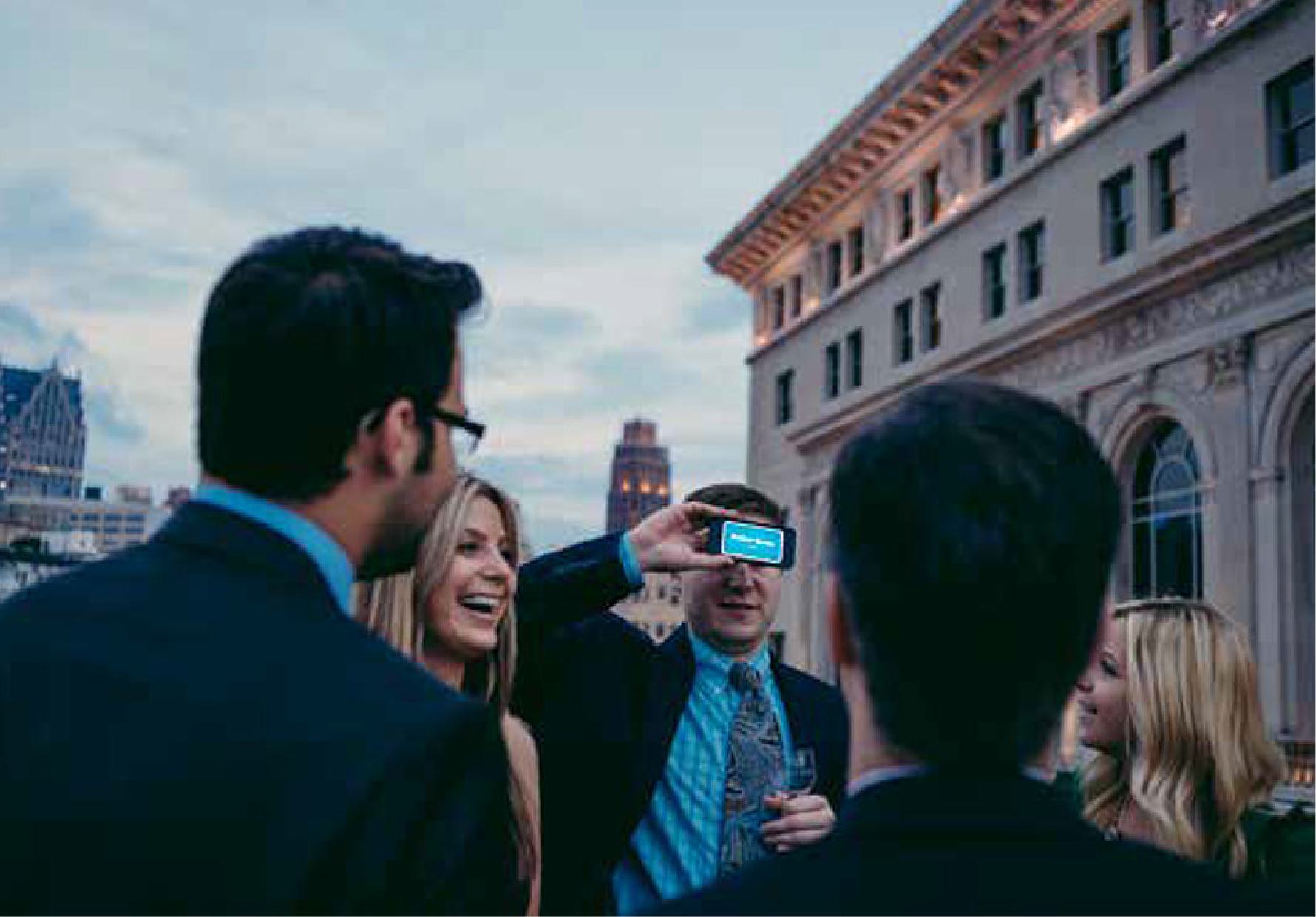 Members mingling at a rooftop event.
