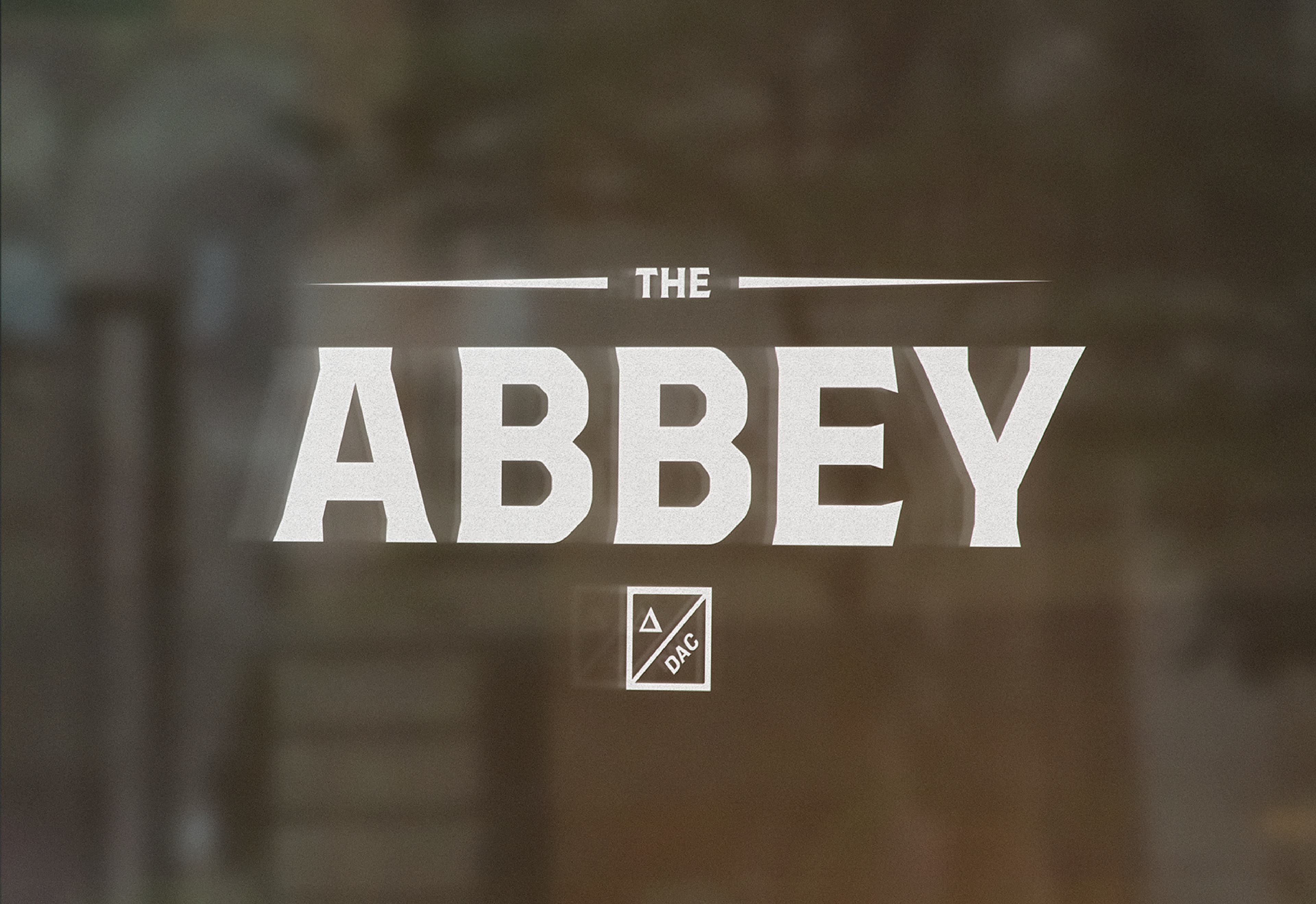The Abbey stencil sign on a glass of a window.
