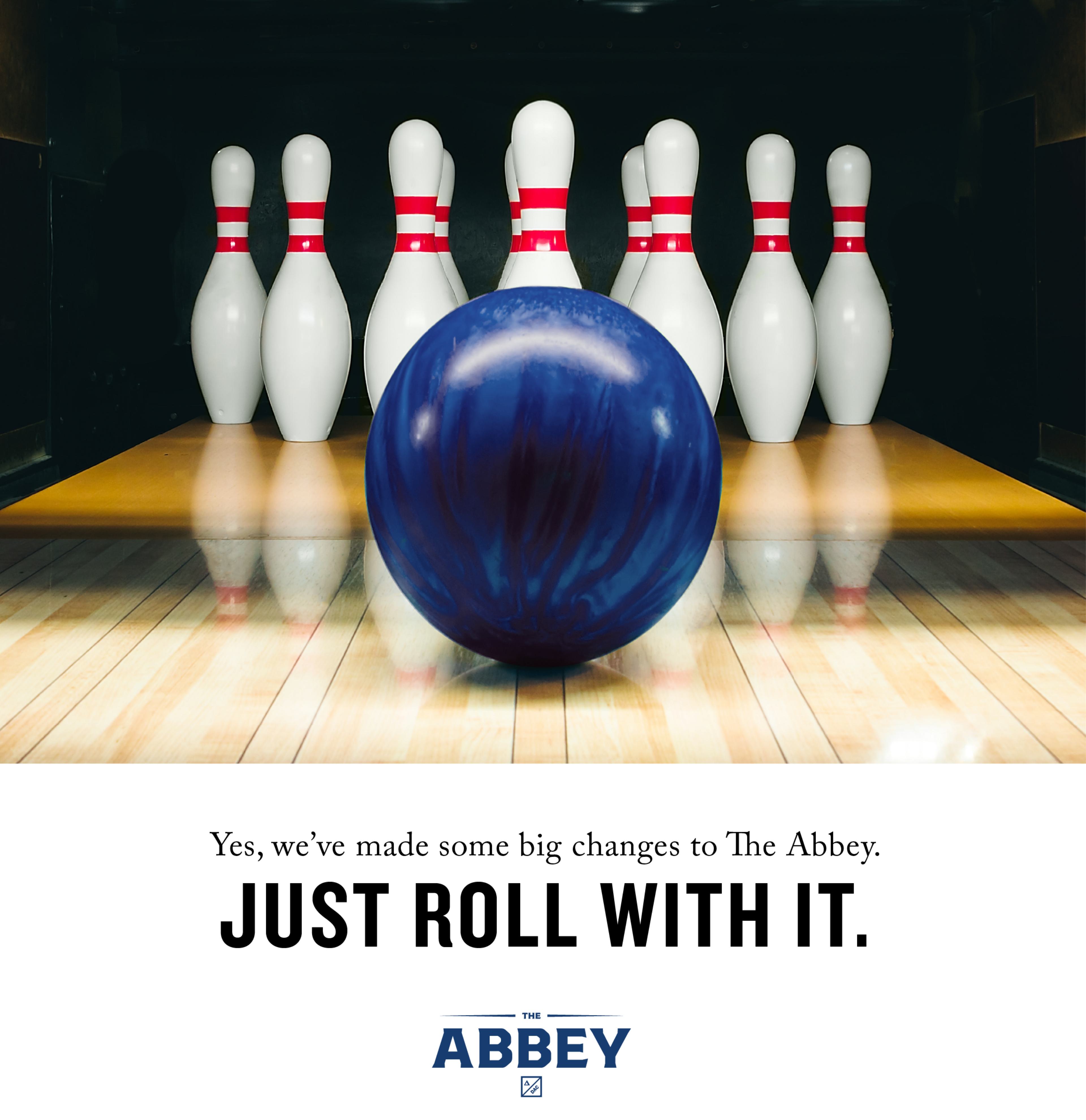 An advertisement for ABBEY with a close up photo of a blue bowling ball at center and front of the 10 pins - Yes, we've made some big chnages to the Abbey. Just roll with it.