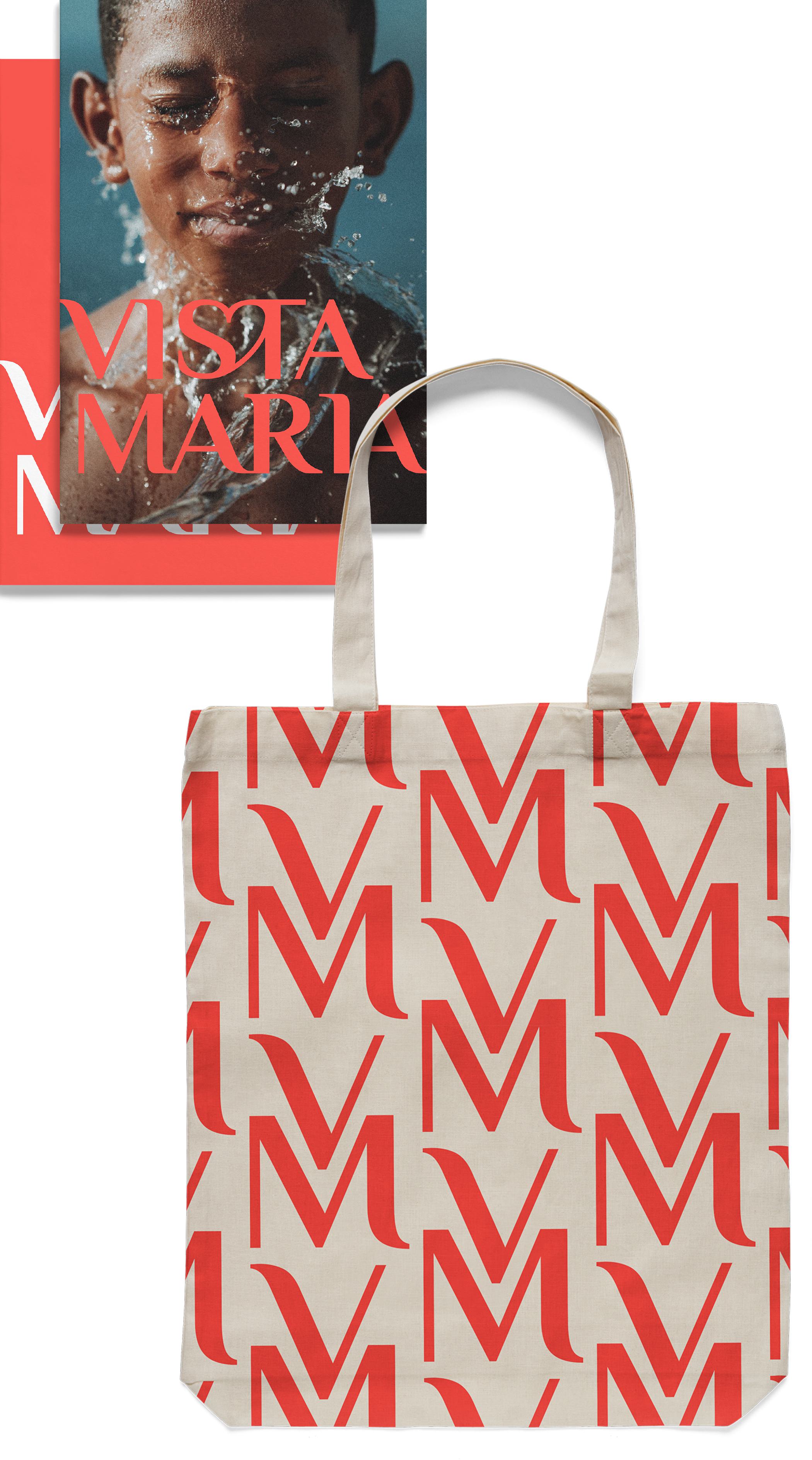 A variety of Vista Maria logo printed goods: books, round pins, and an eco bag.