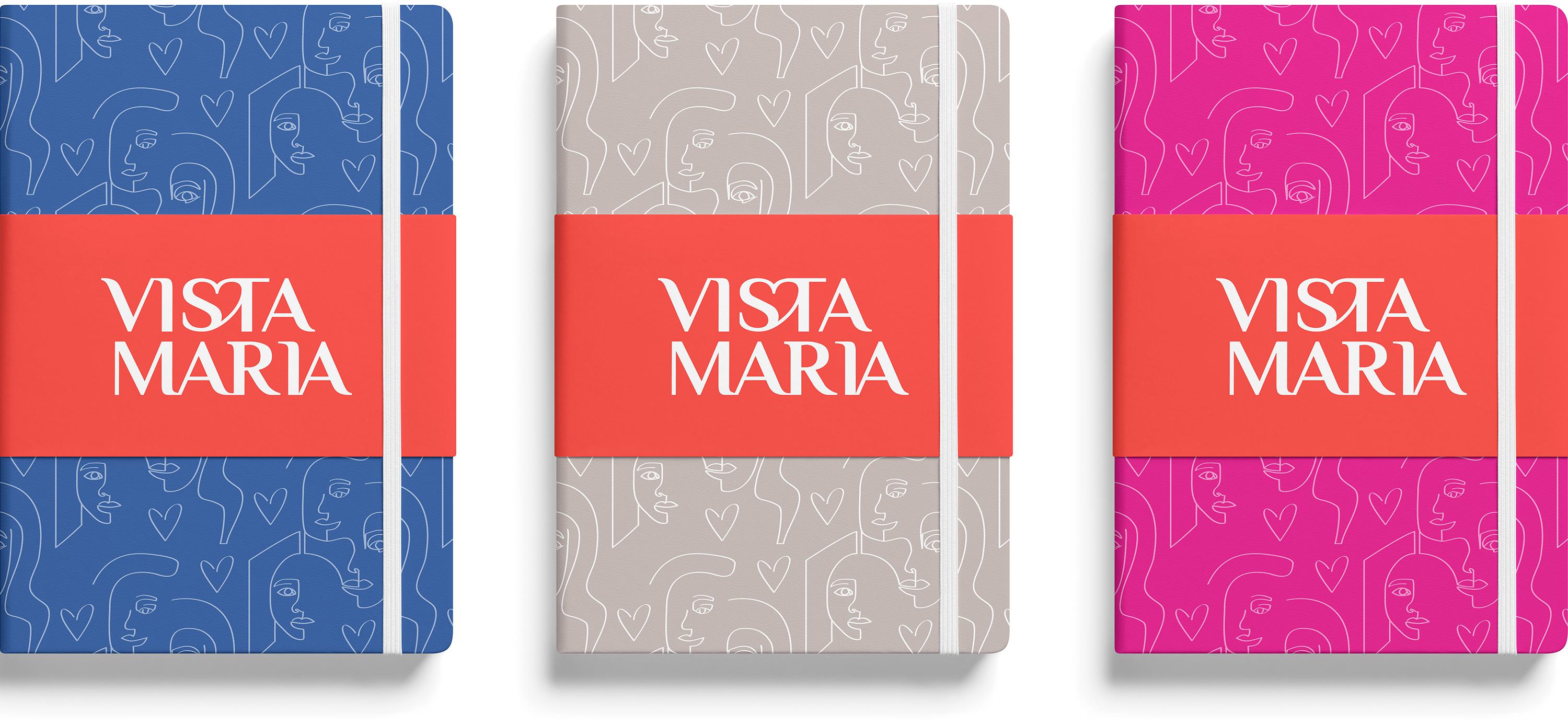 Three Vista Maria branded notebooks with blue, taupe and fuchsia covers.